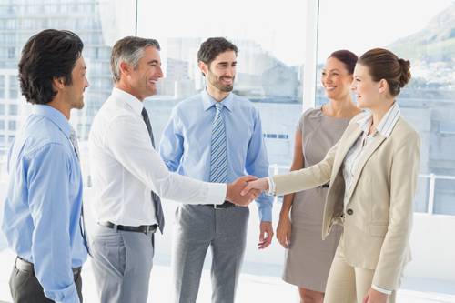 people shaking hands at a business networking group