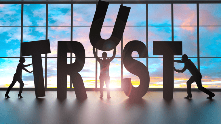 People holding up the word trust