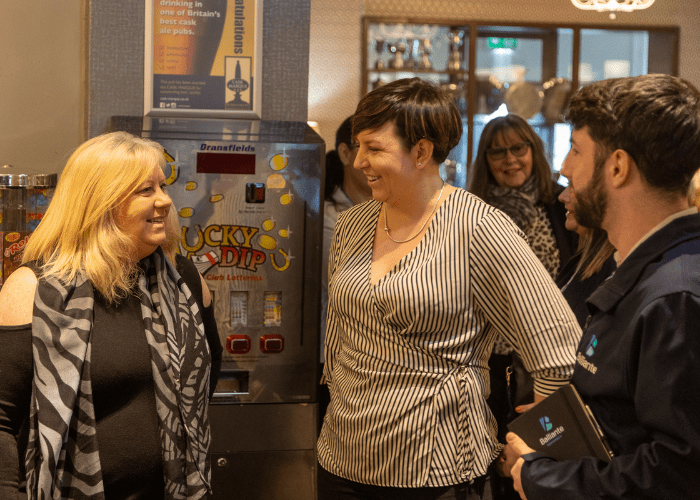 two women talking to each other at a Growth Community meeting
